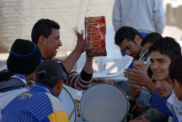 BAGHDAD - Yarmouk public works sub-station (PWSS) workers sing and beat drums during a handover ceremony at Yarmouk in the Mansour district of Baghdad March 16. Four Coalition Forces funded PWSS transferred to the Government of Iraq to promote partne...