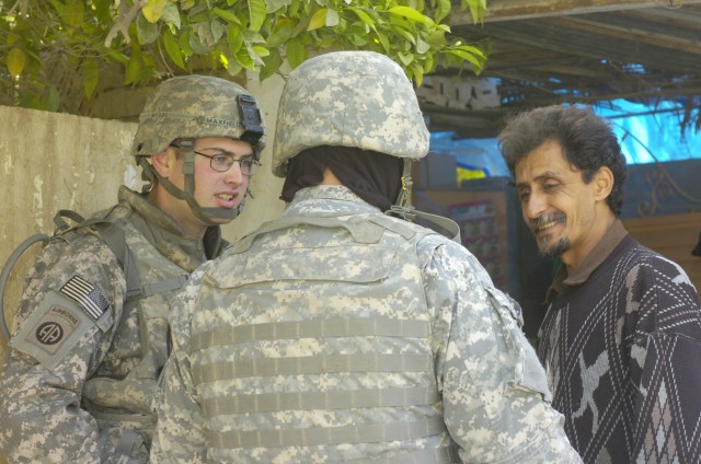 BAGHDAD - Oak Hill, Va. native, 1st Lt. Daniel Maxfield (left), a Military Police platoon leader assigned to the Brigade Special Troops Battalion, 3rd Brigade Combat Team, 82nd Airborne Division, Multi-National Division-Baghdad, speaks with a local s...