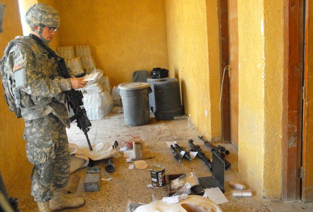 CAMP SLAYER, Iraq - Spc. Steven Richard, an infantryman from Plano, Texas, 2nd Battalion, 8th Cavalry Regiment , 1st Brigade Combat Team, 1st Cavalry Division, marks each piece of evidence from a building search during the Tactical Site...