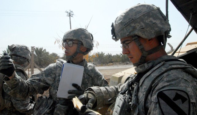 CAMP SLAYER, Iraq -Spc. Steven Richard (left), an infantryman from Plano, Texas, and Spc. Chris White, infantryman from Austin, Texas,  both with 2nd Battalion, 8th Cavalry Regiment , 1st Brigade Combat Team, 1st Cavalry Division, compare notes on...