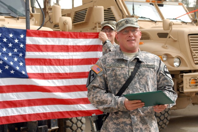 CAMP WAR EAGLE, Iraq - Cuba, Miss. native, Staff Sgt. Christopher Carter, a  Bradley fighting vehicle commander, gives a celebratory speech after reenlisting for an additional eight years March 13.  Carter currently has 12 years of service and plans ...