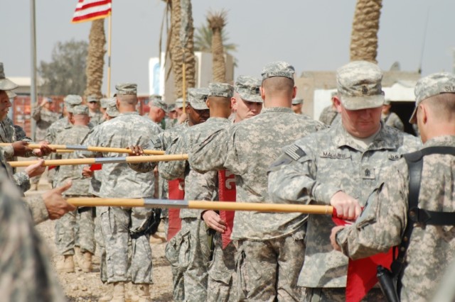 CAMP LIBERTY, Iraq - Soon to be departing theater, company commanders and first sergeants of the 890th Engineer Battalion, from Gulfport, Miss., case their guidons during the transfer of authority ceremony on March 18, in front of the battalion...