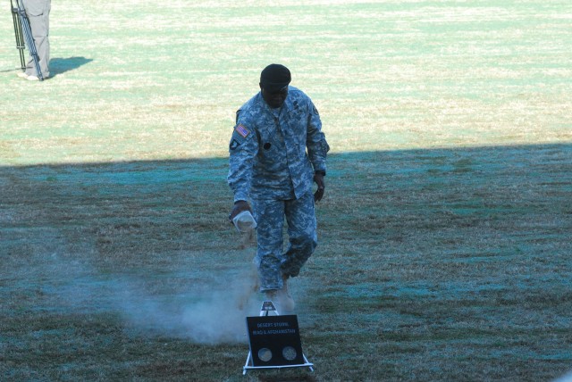CSM Marvin Hill adds soil from from the battlefields of Iraq to the parade field