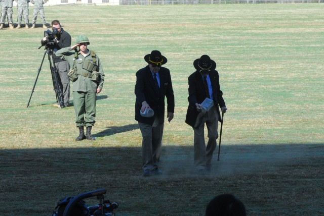 LTG (R) Hal Moore and CSM (R) Basil Plumley add LZ X-Ray soil to the parade field