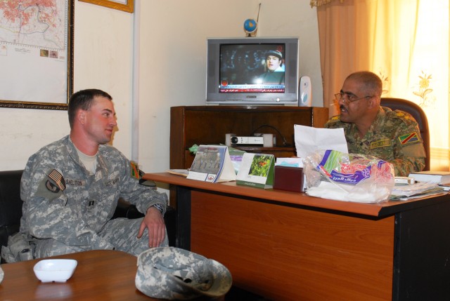 BAGHDAD - Capt. John Shelton (left), Team Weasel, 6th IA Div. MiTT, discusses day-to-day operations with Lt. Col. Haleem Jabir, executive officer, Engineer Regiment, 6th IA Div. Shelton, who hails from Wadsworth, Ohio, advises and assists the enginee...