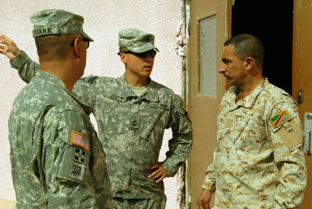 BAGHDAD – Master Sgt. Michael Eddy (center), non-commissioned officer in charge, Team Weasel, 6th IA Div. MiTT, speaks with Sgt. Major Ayad Mohammed Ali Jassem, Intelligence, Surveillance and Reconnaissance Battalion, 6th ID Div. with the help...