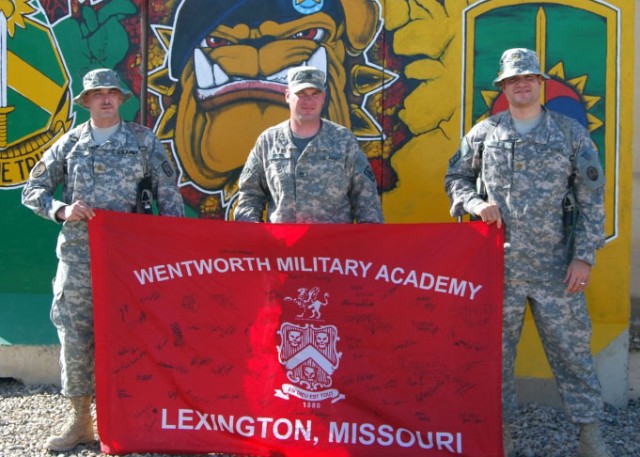 CAMP LIBERTY, Iraq - Wentworth Military Academy graduates unfurled their school colors outside the 8th Military Police Brigade compound and showed "Old Boy" school pride for the Lexington, Mo., academy, March 11 at Camp Liberty.  Pictured from left t...