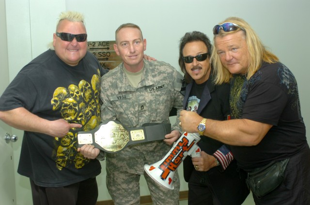 CAMP LIBERTY, Iraq - Wrestling fan and Kempner, Texas native, Sgt. 1st Class Donald Vess (second from left), an intelligence noncommissioned officer with the 1st Cavalry Division, Multi-National Division-Baghdad meets with professional wresting...