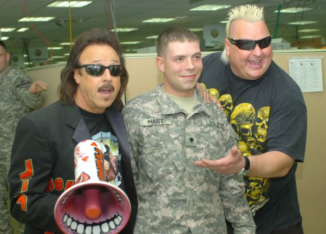 CAMP LIBERTY, Iraq - Dallas native, Spc. William Hart (center), an intelligence analyst with the 1st Cavalry Division, Multi-National Division-Baghdad, who grew up watching wrestling, visits with wrestling legends, Jimmy "Mouth of the South" Hart...