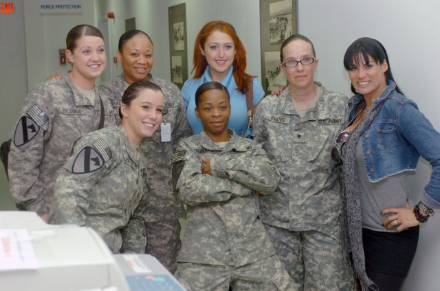 CAMP LIBERTY, Iraq - Soldiers from the 1st Cavalry Division, Multi-National Division-Baghdad jumped at the chance to have their photos taken with professional wrestling stars SoCal Val (center) and Traci Brooks (right) at Camp Liberty, Iraq March...