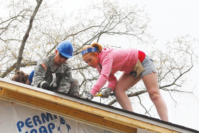 Soldiers, college students work side-by-side to build homes for homeless