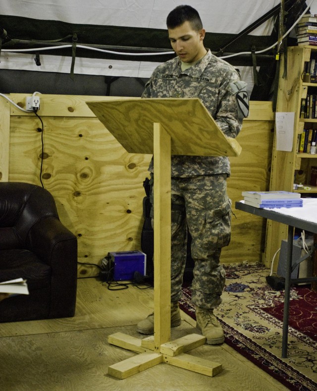 2nd Lt. Walter Gradzik, platoon leader of B Troop, 1st Squadron, 9th Cavalry Regiment, reads a Bible scripture during Catholic Mass at Forward Operating Base Hunter's Solid Rock Chapel recently. Gradzik and Chaplain (Capt.) Timothy Valentine, the Lon...