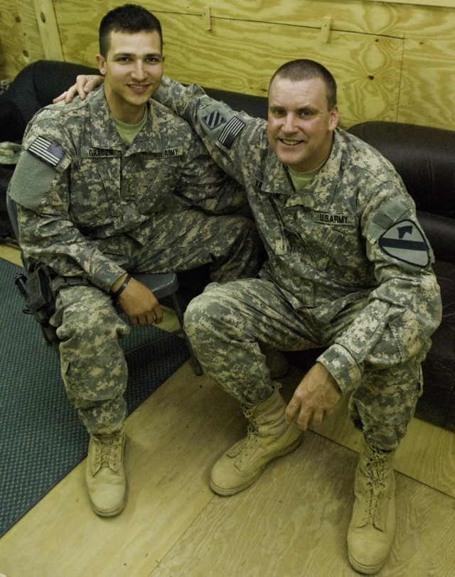 2nd Lt. Walter Gradzik, platoon leader of B Troop, 1st Squadron, 9th Cavalry Regiment, and Chaplain (Capt.) Timothy Valentine, the Long Knife Brigade's Catholic chaplain augmentee, pose for a photo after Mass at Forward Operating Base Hunter's Solid ...