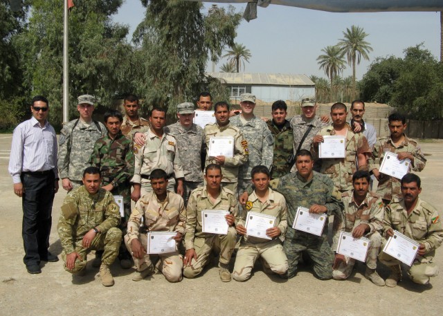 BAGHDAD - Iraqi Army Soldiers serving with the 22nd Brigade, 6th Iraqi Army Division pose for a photo with members of the 22nd Bde., 6th IA Div. Military Transition Team and Company C, 299th Brigade Support Battalion, following a graduation...