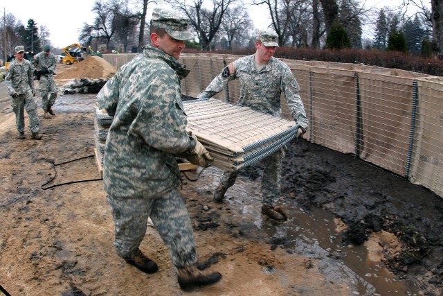 Deployment-hardened Soldiers, Airmen use familiar barriers to dam rising floodwaters