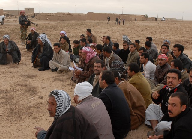 Adult males wait outside of their village while Iraqi Army, Iraqi Police and Soldiers from 4th Squadron, 9th Cavalry Regiment, 2nd Brigade Combat Team, 1st Cavalry Division conduct operation "Dark Horse Cossack Two" in the village of Yourgun,...
