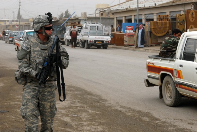Logan, Utah native Pvt. Joshua Roberts, an infantryman for 1st Battalion, 8th Cavalry Regiment, 2nd Brigade Combat Team,1st Cavalry Division pulls security for Iraqi Army and U.S. Soldiers that are making the last Coalition Forces backed payment...