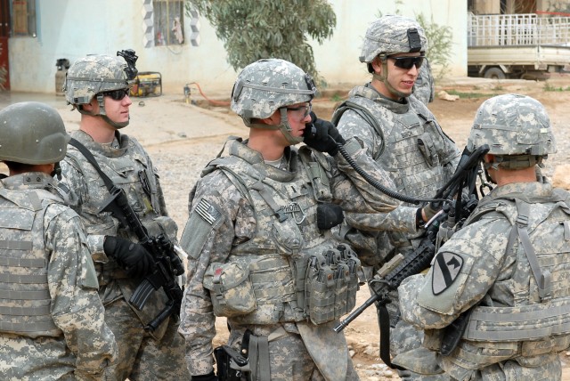 Soldiers from 1st Battalion, 8th Cavalry Regiment, 2nd Brigade Combat Team,1st Cavalry Division coordinate security in the city of Zaab March 3, for Iraqi Army and U.S. Soldiers that are making the last payment to the Sons of Iraq before the...