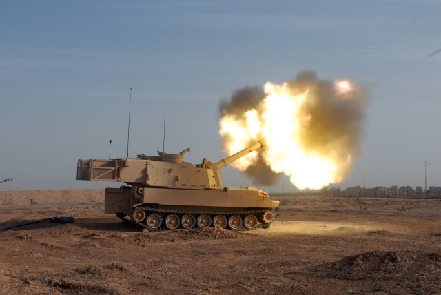 Flames erupt from the end of the barrel of a M109A6 self-propelled 155MM Howitzer, also known as Paladin, as it fires a round on Forward Operating Base Warrior, Kirkuk, Iraq. This is the first time this particular Paladin has been fired in Iraq...