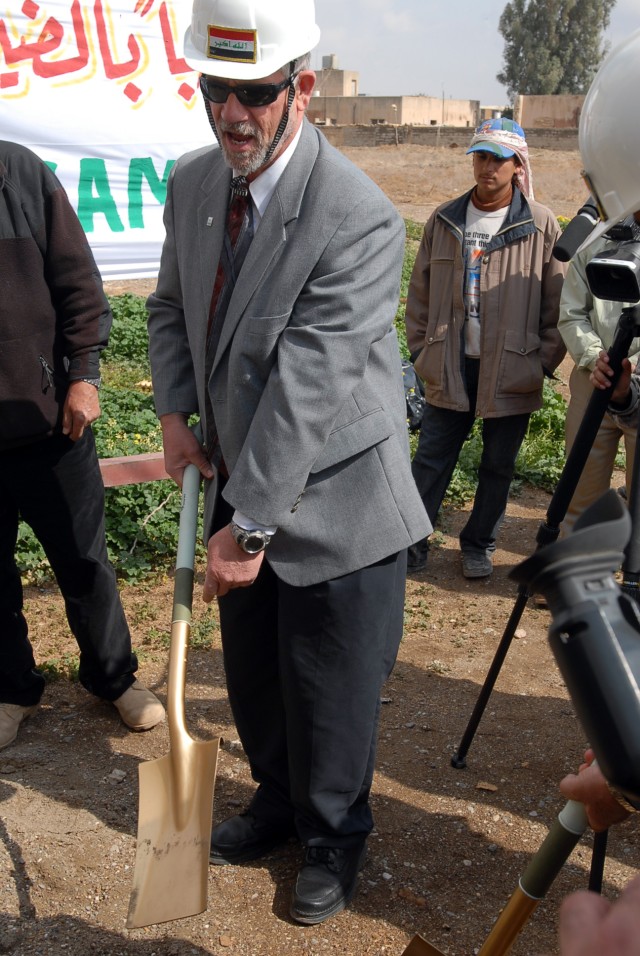 Jim Vancura, the senior agricultural advisor for Forward Operating Base Warrior's Provincial Reconstruction Team, strikes dirt with a golden shovel symbolizing the start of renovations and construction at the Kirkuk grain silo, Kirkuk city, Iraq, Mar...