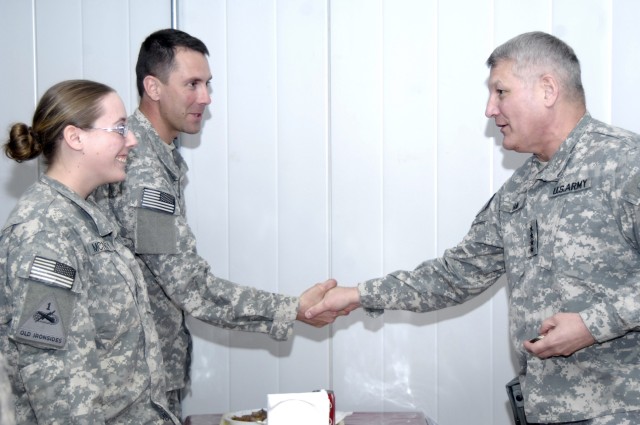BAGHDAD - Soldiers from the 2nd Brigade Combat Team, 1st Armored Division, Multi-National Division-Baghdad, receive coins from Gen. Carter Ham (right), commanding general of U.S. Army Europe, during his visit to Camp Striker, Iraq, March 25. Ham...