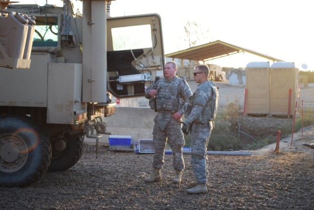 CAMP TAJI, Iraq - Spc. Joshua Pastir (right) and Pfc. Jeremiah Pomerleau (left), Soldiers from 3rd Platoon, 62nd Engineer Company, 4th Engineer Battalion, 225th Engineer Brigade, discuss their vehicle's load plan while conducting pre-combat checks pr...