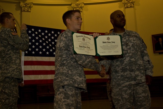 Sgt. Derrick Doyle, from Philadelphia, unit movement officer, Headquarters Support Company, 615th Aviation Support Battalion, 1st Air Cavalry Brigade, 1st Cavalry Division, shakes hands with his platoon leader, 2nd Lt. Thomas Horal, 615th ASB, 1st...