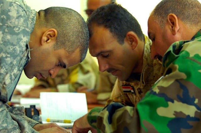 BAGHDAD-Capt. Charlie Silva (left), a native of Sabana Grande, Puerto Rico and the intelligence advisor for the 11th Iraqi Army Division Military Transition Team, gets hands-on with his Iraqi Army students during a March 22 block of instruction on ba...