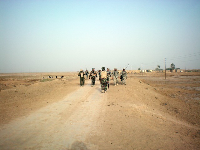 Soldiers assigned to the 3rd Battalion, 41st Iraqi Army Brigade, and 5th Battalion, 82nd Field Artillery Regiment, 4th Brigade Combat Team, 1st Cavalry Division, travel toward the Al Kahla River in southern Iraq to speak with Iraqi citizens about...