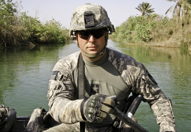 1st Lt. Donald J. Frisco, a platoon leader with Battery A, 5th Bn., 82nd Field Artillery Regiment, 4th Brigade Combat Team, 1st Cavalry Division, paddles down Victory Canal in search of criminal smugglers during Operation Chattahoochee, a joint...