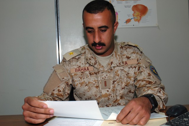CAMP TAJI, Iraq - 2nd Lt. Bahaa Sabree Fakhre, deputy commander of the Iraqi Army medical clinic, reviews the schedule for upcoming sustainment training with the Iraqi Security Forces Partnership Team, March 19. Bahaa, who is also the dentist, has...