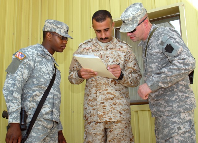 CAMP TAJI, Iraq - 2nd Lt. Bahaa Sabree Fakhre, deputy commander of an Iraqi Army medical clinic, discusses details about the schedule for upcoming sustainment training with Langston, Pa. native, Spc. Dante Wyrick, and Sgt. Christopher Walker, who...
