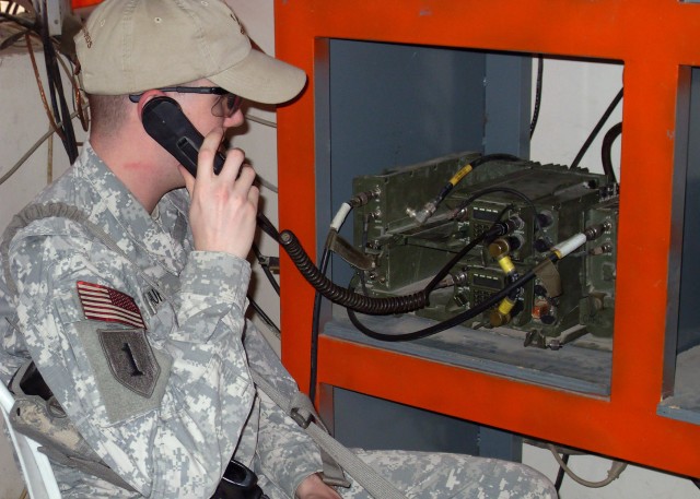 BAGHDAD - Franklin, Ga. native, Pfc. Jason Huff, a signal support systems specialist, 1st Combined Arms Battalion, 18th Infantry Regiment, 2nd Heavy Brigade Combat Team, 1st Infantry Division, Multi-National Division -- Baghdad, performs a radio...