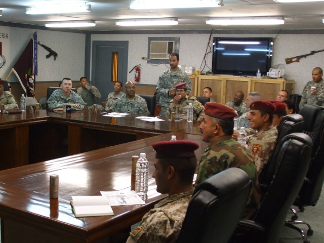 BAGHDAD -Maj. Duhmad (center) and the staff of the 17th Iraqi Army Division Military Transport Regiment (MTR) receives a briefing on the structure of the 47th Forward Support Battalion, 2nd Brigade Combat Team, 1st Armored Division, Multi-National...