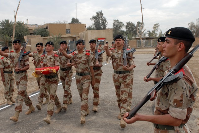 BAGHDAD - Iraqi Military Academy - Rustamiyah cadets march with the Iraqi flag during a ceremony to transfer Forward Operating Base Rustamiyah back over to Iraqi officials here March 31. The cadets go through a nine-month long course that focuses on ...