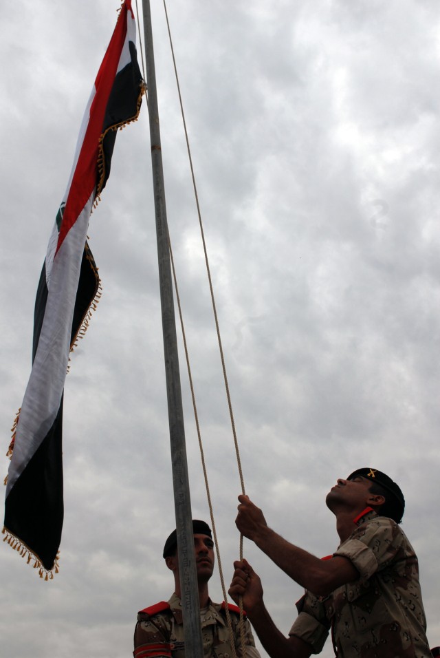 BAGHDAD - Iraqi Military Academy - Rustamiyah cadets raise the Iraqi flag during a ceremony to transfer Forward Operating Base Rustamiyah back over to Iraqi officials here March 31. The last portion of FOB Rustamiyah was transferred back over to the ...