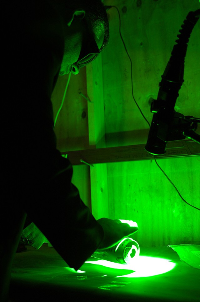 VICTORY BASE COMPLEX, Iraq - A member of the Iraqi Investigation Committee gets hands on training with various shades of infrared light sources to find finger prints on different objects March 30 at the Joint Expeditionary Forensics Facility on...