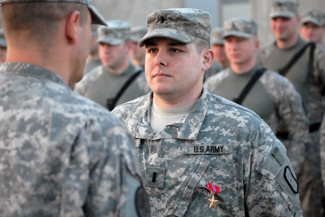 BAGHDAD - Texarkana, Texas native, 1st Lt. Richard Warehime, platoon leader for 2nd Platoon, 688th Engineer Company, 890th Eng. Battalion, 225th Engineer Brigade, Multi-National Division - Baghdad is pinned with the Bronze Star Medal, which awards...