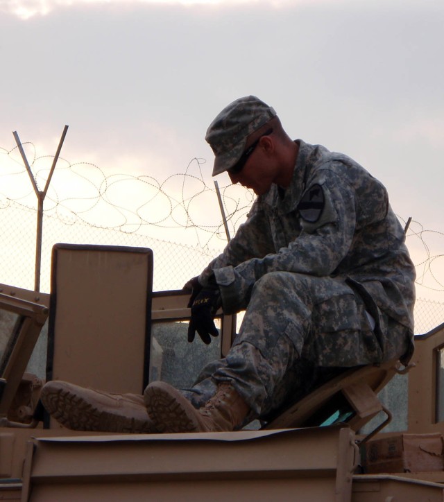BAGHDAD-Milwaukee, Wis. native Cpl. Michael Orwig, a tank gunner for Company B, 2nd "Lancer" Battalion, 5th Cavalry Regiment, 1st "Ironhorse" Brigade Combat Team, 1st Cavalry Division completes his maintenance checks on a M1A2SEP tank March 31 in...
