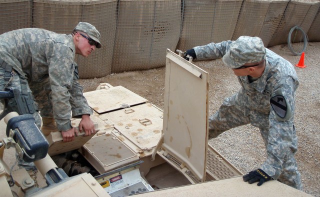 BAGHDAD-Hickory, N.C. native, Pfc. David Weiss (left), driver for Company B, 2nd "Lancer" Battalion, 5th Cavalry Regiment, 1st "Ironhorse" Brigade Combat Team, 1st Cavalry Division and Milwaukee, Wis. native, Cpl. Michael Orwig (right),  a tank...