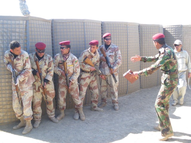 2nd Lt. Mohammed, an Iraqi Army platoon leader assigned to 3rd Battalion, 40th Iraqi Army Brigade, coaches his Soldiers through a room clearing exercise during a three-day joint training exercise with their American counterparts from 2nd...