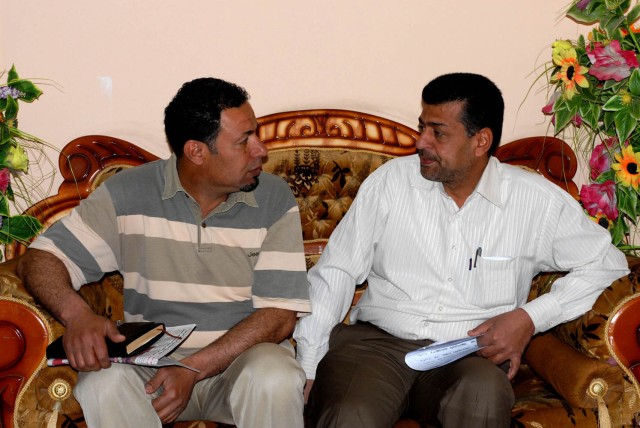 BAGHDAD - Ali Sewadi Rahima Al-Shmusi (left) and Ibrahim Kadhim Bahar (right), both Jameela Neighborhood Advisory Council members, discuss different avenues to provide the Iraqi people with more essential services and provide a more secure...