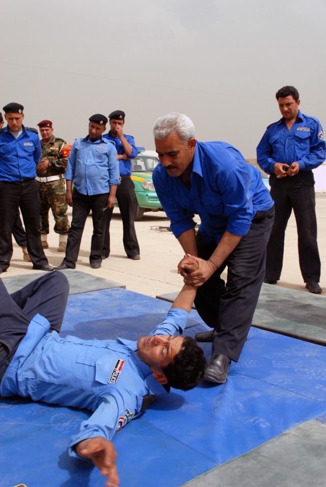 BAGHDAD - Iraqi Policemen practice takedown techniques during Scorpion Academy, a three-day training seminar, at Joint Security Station Salaam. The academy is meant to reinforce the Iraqis' troop tactical procedures as well as encourage...