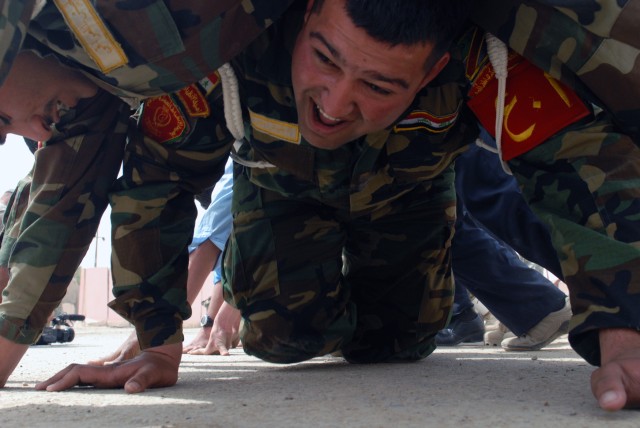 BAGHDAD - An Iraqi Soldier with the 6th IA Div. performs a POW crawl, a team building exercise also meant to enforce discipline, according to Spc. Franklin Land III, 978th MP Co. "The POW crawl is where you get everyone in line in the pushup...