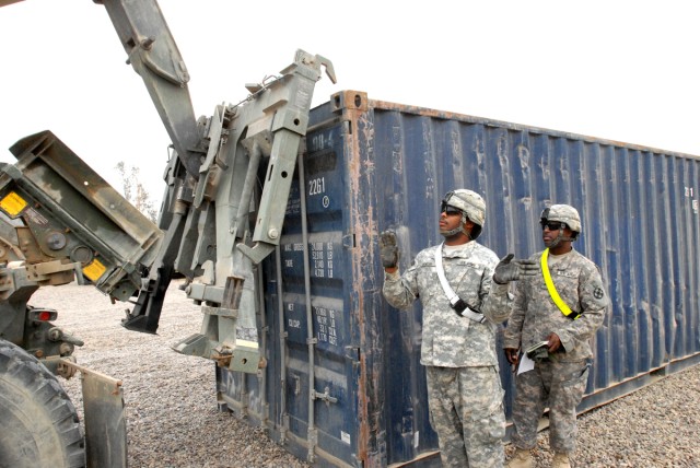 CAMP LIBERTY, Iraq - Pfc. Craig Hunter, from Newport News, Va., a truck driver of the 89th Transportation Company, attached to the 553rd Combat Sustainment Support Battalion, 10th Sustainment Brigade, receives instruction here March 30, from Sgt....