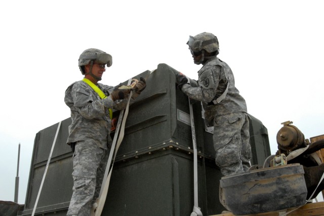 CAMP LIBERTY, Iraq - Cpl. Mark Harrington, from Brockton, Mass., a truck driver of the 154th Transportation Co. and Chicago native, Pfc. Antonio Littleton of the 89th Transportation Co., 553rd Combat Sustainment Support Battalion, 10th Sustainment...