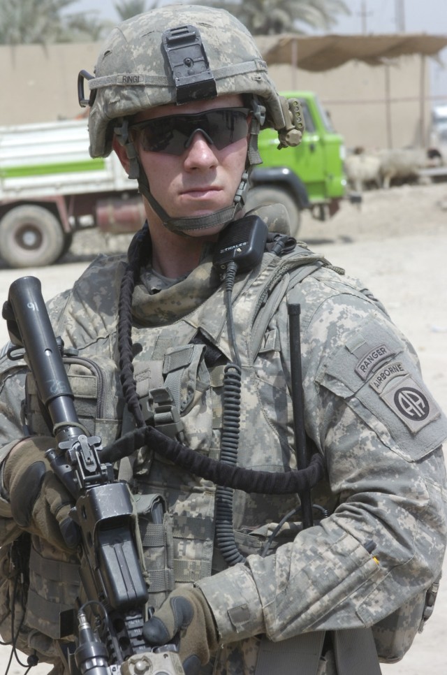 SHAWRA WA UM JIDIR, Iraq - Spc. Ryan Ringi, of Suffolk, N.Y. checks his surroundings during a foot patrol April 4 inside a market in the city of Shawra Wa Um Jidir, located in the 9 Nissan district of eastern Baghdad. Ringi, an infantryman, assigned ...