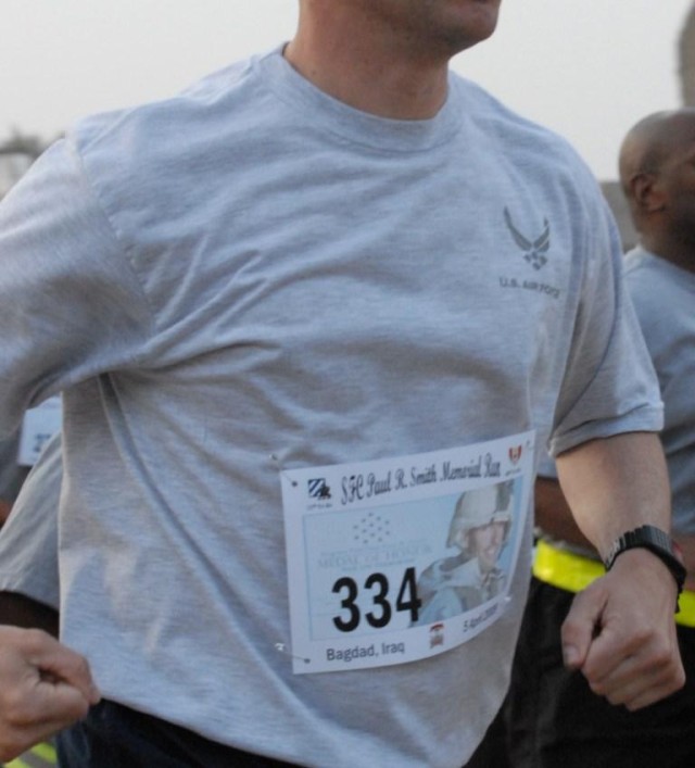BAGHDAD - A participant of the Sgt. 1st Class Paul R. Smith Memorial Run displays the photo of the fallen hero on April 5 in Baghdad. Smith, posthumously awarded the Medal of Honor,  lost his life six years ago when his platoon was attacked near...