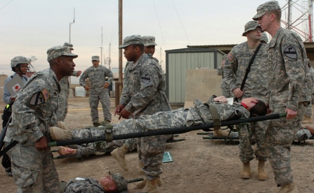 CAMP LIBERTY, Iraq - Amid a sea of other Soldiers, Charleston, S.C. native, Sgt. Sean Thompson (left), a multi-channel transition systems operator, and Pfc. Roy Perritt (far right) of Mullins, S.C., a signal support systems specialist, both with...