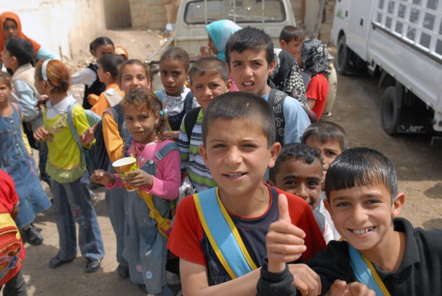 BAGHDAD - Students from the Um Araybia School in western Baghdad show their excitement while they wait for their newly arrived school supplies to be distributed by members of the 2nd Battalion, 112 Infantry Regiment, and the 225th Engineer Brigade, M...
